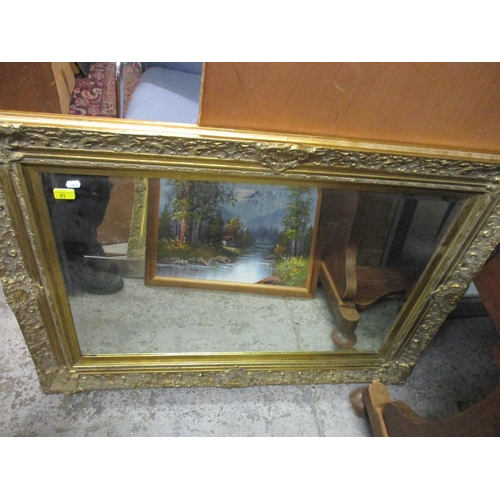 21 - A contemporary gilt framed wall mirror with shell, floral and c-scroll decoration, bevelled glass re... 