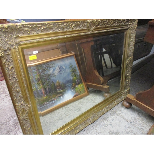 21 - A contemporary gilt framed wall mirror with shell, floral and c-scroll decoration, bevelled glass re... 