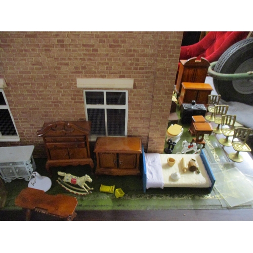 24 - A dolls house with a double front and various dolls house furniture. Location:G