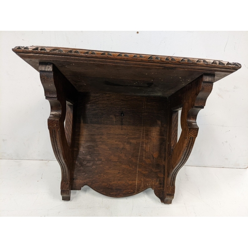 113 - An early 20th century oak shelf with a carved border and shaped brackets, 45.5h x 50.5w
Location: LA... 