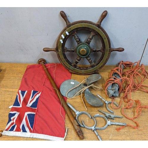 178 - Boat related items to include a ships wheel, a propeller, a flag and an anchor
Location: G