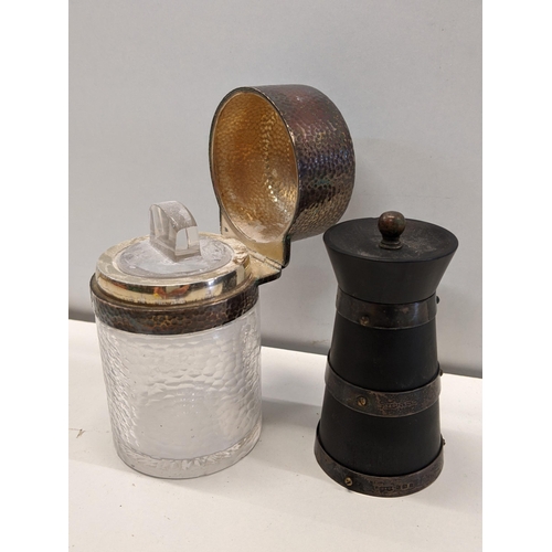 19 - An early 20th century silver mounted pepper grinder of churn form, together with a silver topped dre... 