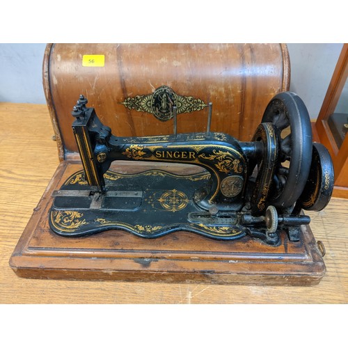 56 - A Singer sewing machine No7637696 1900296 in case, and a Griffin & George Ltd chemist scales
Locatio... 