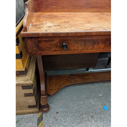 7 - A late Victorian mahogany wash stand with a gallery over two drawers and twin vase shaped ends, on b... 