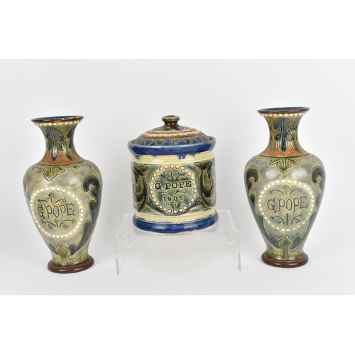 19 - A collection of Royal Doulton pottery, to include a pair of Edwardian vases and lidded pot with G. P... 