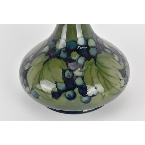 2 - A Walter Moorcroft glazed vase in the 'Leaf and Berry' pattern, of squat form with a long knopped ne... 