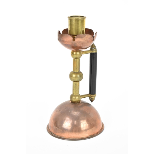 23 - A late 19th century Arts & Crafts copper and brass candlestick in the manner of Christopher Dresser,... 