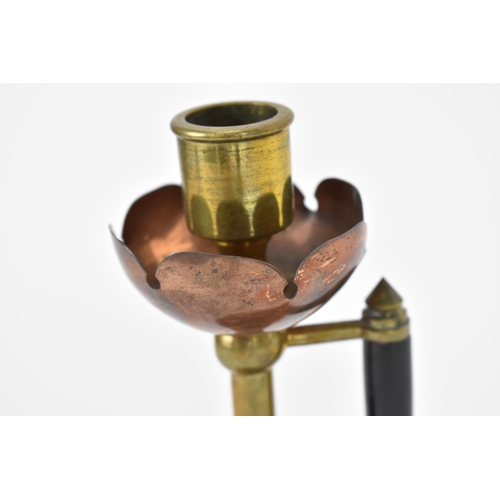 23 - A late 19th century Arts & Crafts copper and brass candlestick in the manner of Christopher Dresser,... 