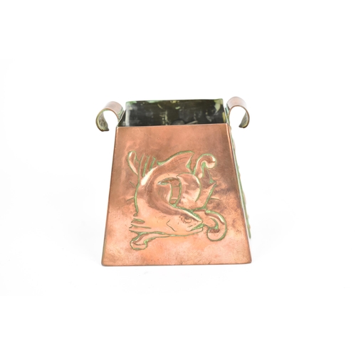 31 - An Arts & Crafts Newlyn copper pot, of square tapered form with embossed fish and a gull with a fish... 