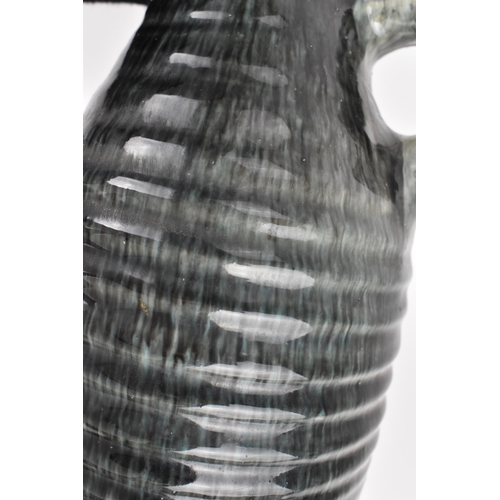 32 - A French mid century studio pottery vase by Accolay jug, designed with long tapered ribbed neck in g... 