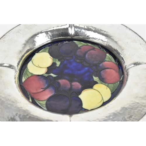 5 - An early 20th century Moorcroft pottery and pewter charger, probably for Liberty & Co, in the 'Plum ... 