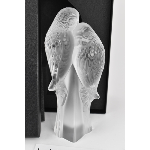 39 - A Lalique crystal model of two parakeets, modelled in frosted and clear glass, the two birds perched... 