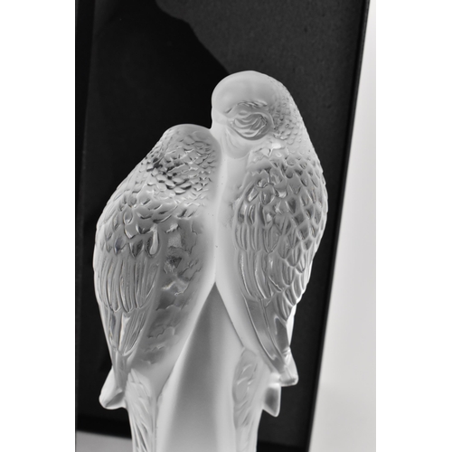 39 - A Lalique crystal model of two parakeets, modelled in frosted and clear glass, the two birds perched... 