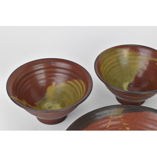 76 - A set of five Studio pottery bowls and two ramekins, in earthenware with tenmoku style glazing, each... 