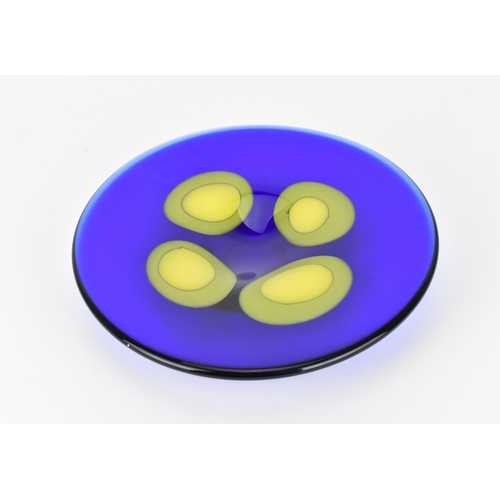 94 - A Czech studio glass dish by Ales Valner, of circular form in cobalt blue with four yellow blobs to ... 