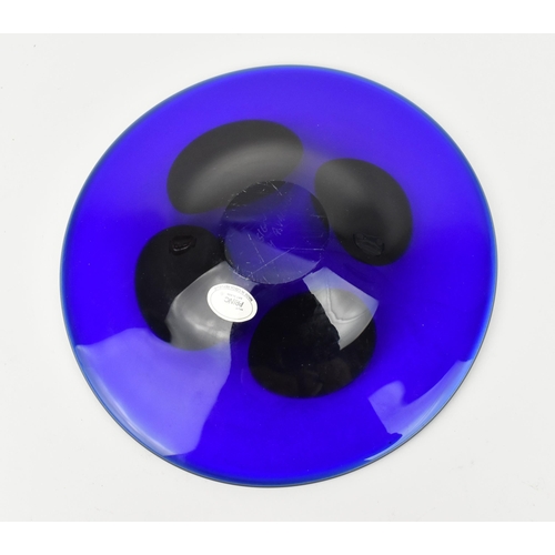 94 - A Czech studio glass dish by Ales Valner, of circular form in cobalt blue with four yellow blobs to ... 