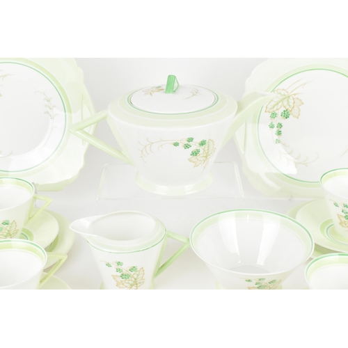 119 - An early 20th century Art Deco Shelley tea set, circa 1930s, in a green design with berries on leaf ... 