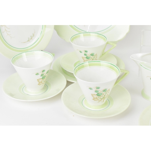 119 - An early 20th century Art Deco Shelley tea set, circa 1930s, in a green design with berries on leaf ... 