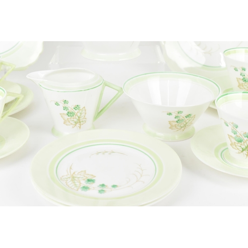 119 - An early 20th century Art Deco Shelley tea set, circa 1930s, in a green design with berries on leaf ... 