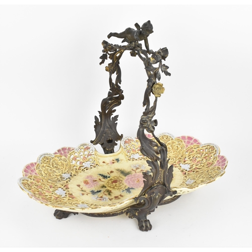 124 - A large Zsolnay reticulated ceramic basket, sitting in a cast bronze frame with acanthus leaves, flo... 