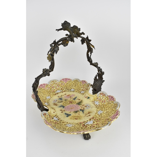 124 - A large Zsolnay reticulated ceramic basket, sitting in a cast bronze frame with acanthus leaves, flo... 