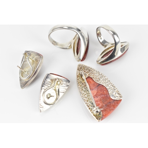 156 - A silver and red coral jewellery suite, comprising of two rings, a pair of earrings and a brooch