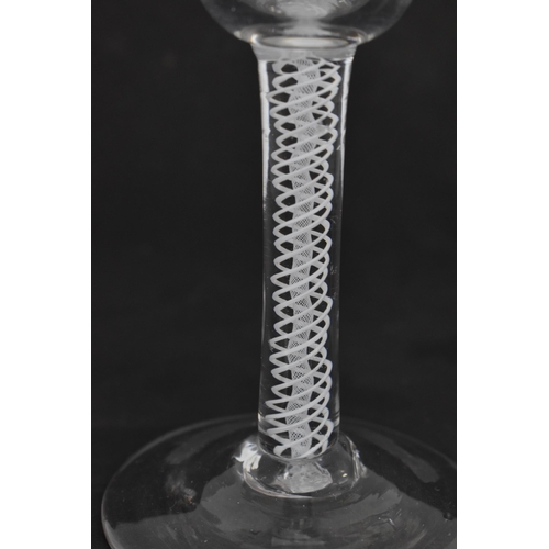 174 - A group of four Georgian wine glasses, each with ogee bowl, on air twist stems, one with red twist, ... 