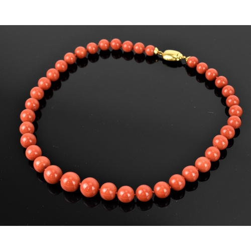 180 - An Italian 18ct yellow gold and red coral single strand bead necklace and pair of matching earrings,... 