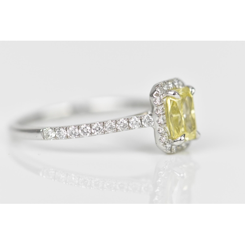 181 - A fancy intense yellow diamond and diamond cluster ring, the cut corner rectangular modern brilliant... 