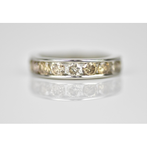 187 - A platinum and diamond half eternity ring, with ten channel set round brilliant cut diamonds, carat ... 