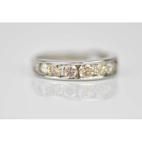 187 - A platinum and diamond half eternity ring, with ten channel set round brilliant cut diamonds, carat ... 