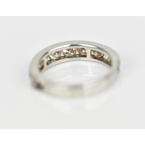 187 - A platinum and diamond half eternity ring, with ten channel set round brilliant cut diamonds, carat ... 