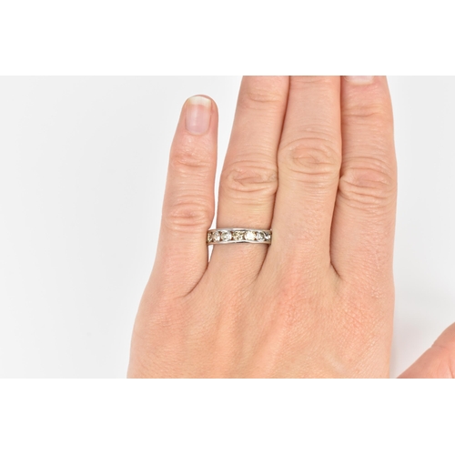 187 - A platinum and diamond half eternity ring, with ten channel set round brilliant cut diamonds, carat ... 