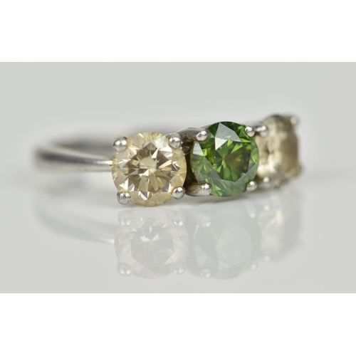 189 - A three stone platinum and diamond ring, with central green diamond, flanked by two similar sized br... 