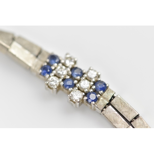 191 - An 18ct white gold, diamond and blue sapphire bracelet, the two articulated strands with six diamond... 