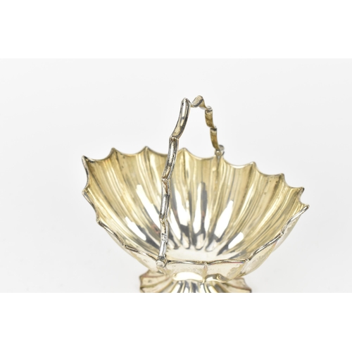 205 - A George III silver sugar bowl by Thomas Howell, London 1779, of fluted oval design, with swing hand... 