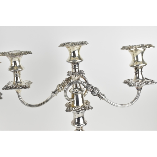 209 - A near pair of silver-plated three-light candelabra, in the Georgian style with scrolled arms, the t... 