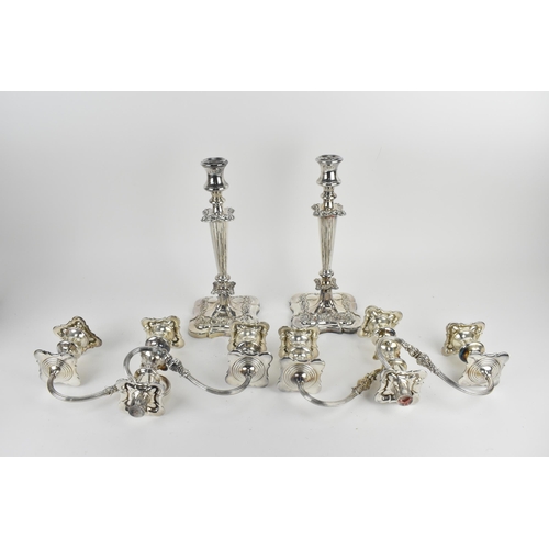 209 - A near pair of silver-plated three-light candelabra, in the Georgian style with scrolled arms, the t... 