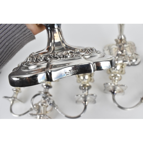 209 - A near pair of silver-plated three-light candelabra, in the Georgian style with scrolled arms, the t... 