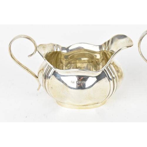 210 - A George V silver twin-handled sugar bowl, Sheffield 1916, with matching milk jug, makers initials P... 