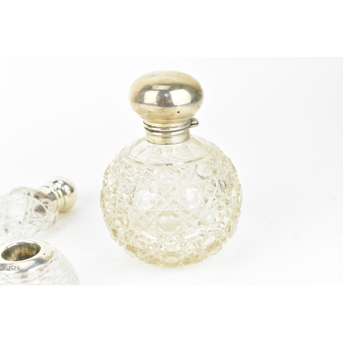 211 - An Edwardian silver and cut glass scent bottle, the silver Birmingham 1910, of globular form with ho... 