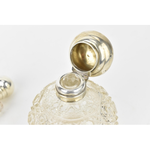 211 - An Edwardian silver and cut glass scent bottle, the silver Birmingham 1910, of globular form with ho... 