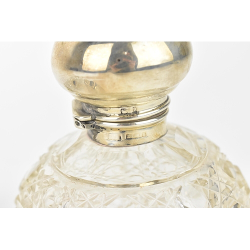 211 - An Edwardian silver and cut glass scent bottle, the silver Birmingham 1910, of globular form with ho... 