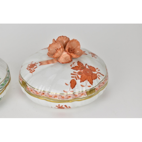 105 - Two Herend porcelain lidded boxes in the 'Apponyi' pattern, green and orange, each with Chinese bouq... 