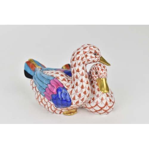 110 - Two Herend porcelain animal models, to include a group of two loving ducks in red fishnet with gilt ... 