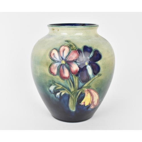 132 - A Walter Moorcroft pottery vase in the 'Spring flowers' pattern, of baluster form with tube-lined bl... 