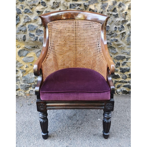 160 - A William IV mahogany and canework library bergere chair, in the Gillows style with curved rail and ... 