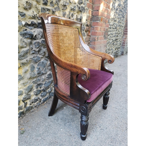 160 - A William IV mahogany and canework library bergere chair, in the Gillows style with curved rail and ... 