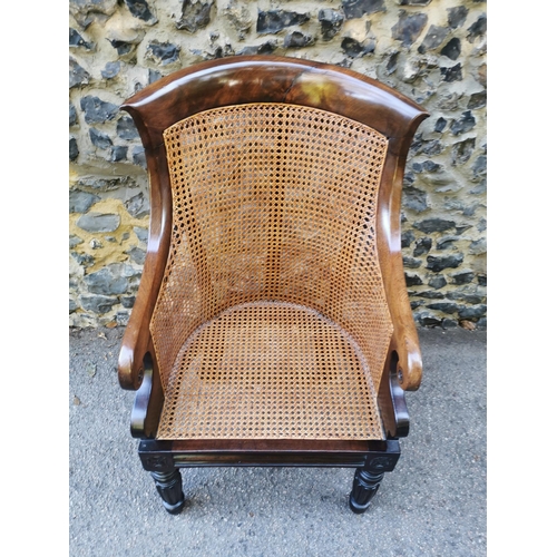 160 - A William IV mahogany and canework library bergere chair, in the Gillows style with curved rail and ... 