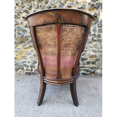 160 - A William IV mahogany and canework library bergere chair, in the Gillows style with curved rail and ... 